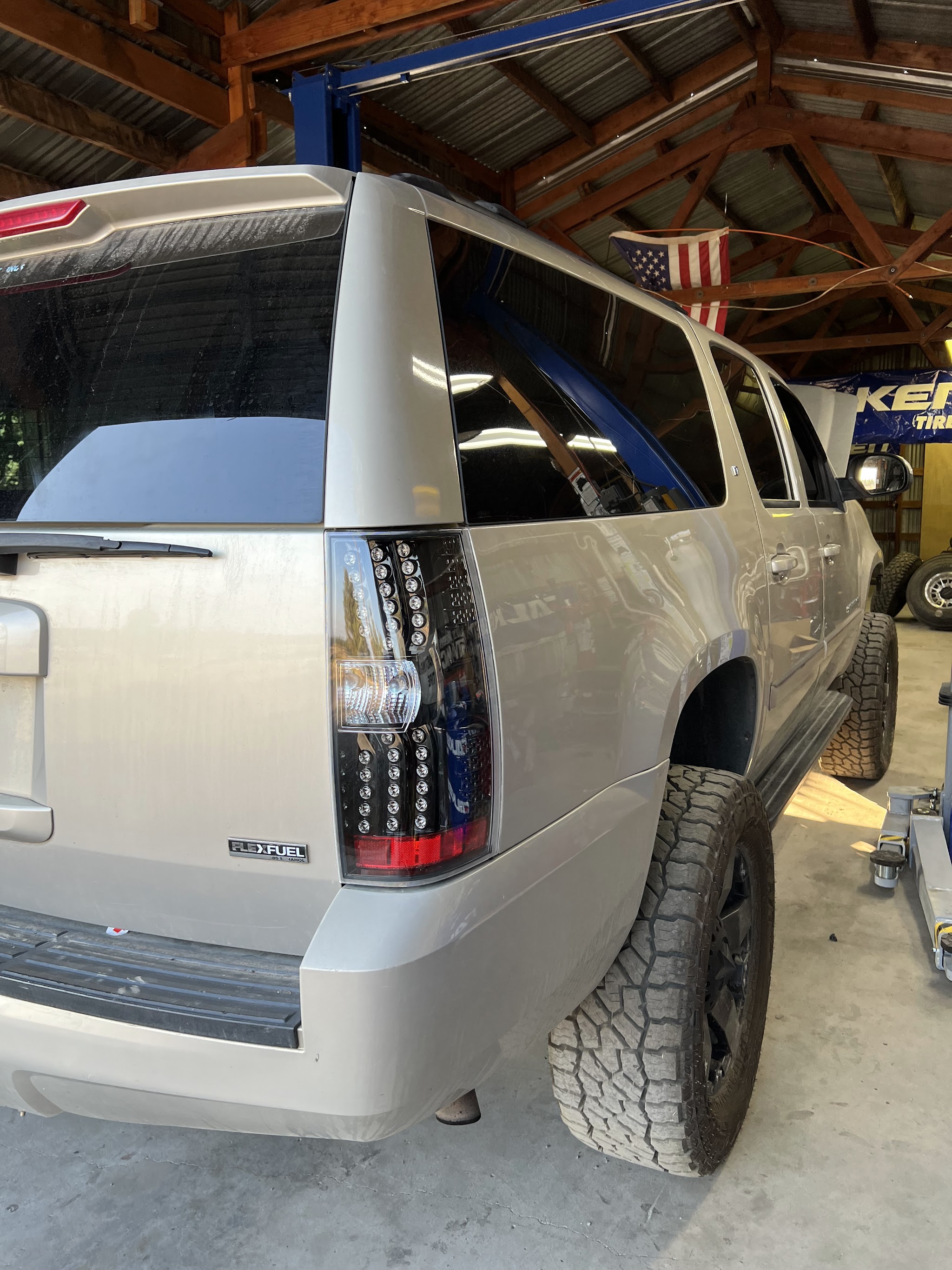 An SUV on all terrain tires parked in the Hastings Tire & Offroad shop