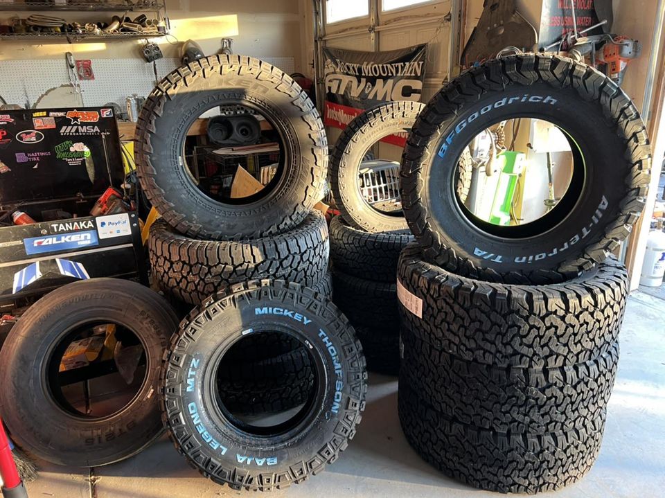 Stacks of all terrain and mud terrain tires waiting in the shop